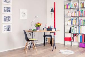 kleiner Arbeitstisch mit zwei Sitzplätzen. Stühle: Eames Chair DSW und Basel Chair, beides Vitra, Tischleuchte Tolomeo, Artemide